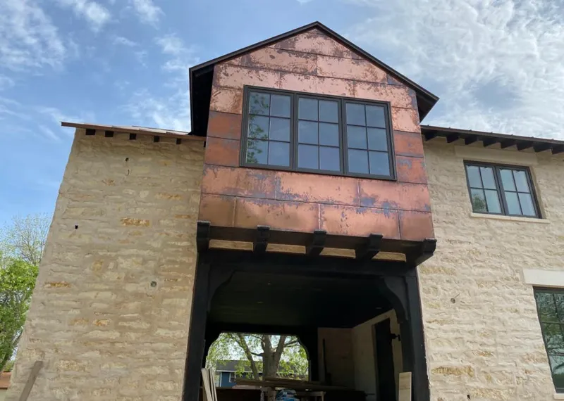 Copper metal panel facade on a stone building for Skylight Installation in Snyder